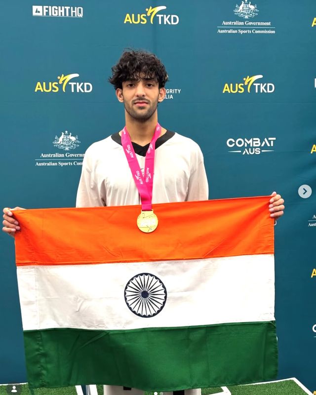 Nitesh Singh with the Indian flag and a gold medal